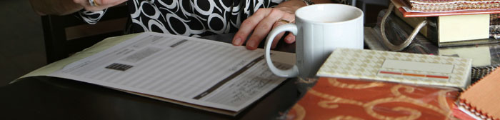 Designer sitting at table with stacks of samples